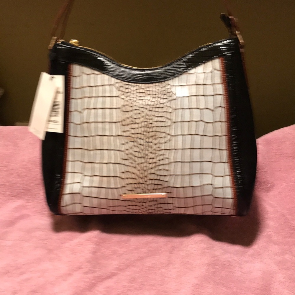 Sophisticated shoulder bag with a secure zip top closure and spacious interior